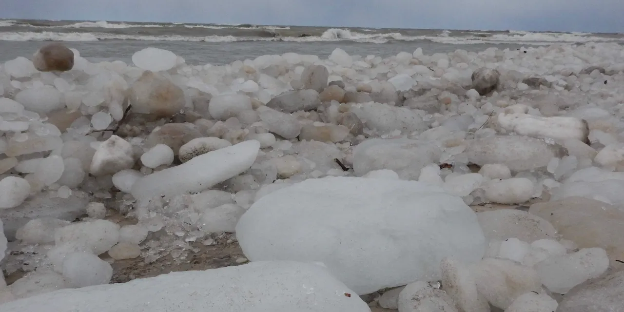 Frozen beach with scattered ice boulders