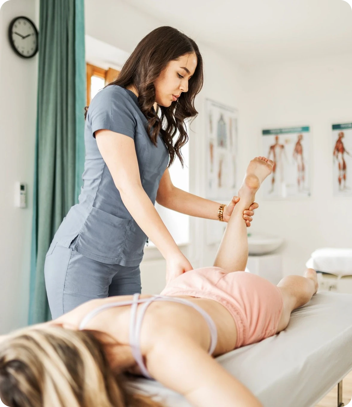 Physical therapist stretching patient's leg