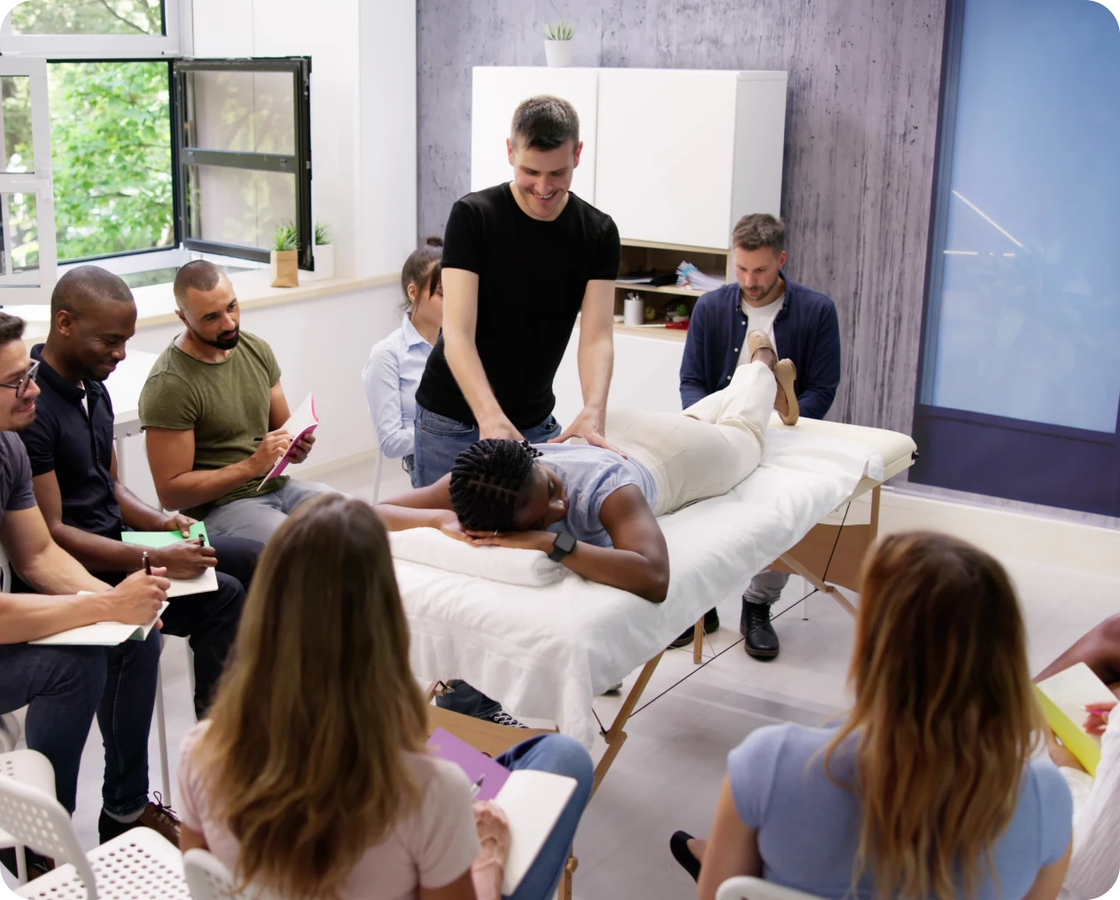 Instructor teaching massage techniques