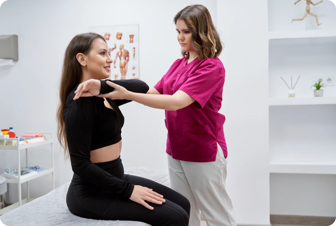Therapist assisting with shoulder exercise