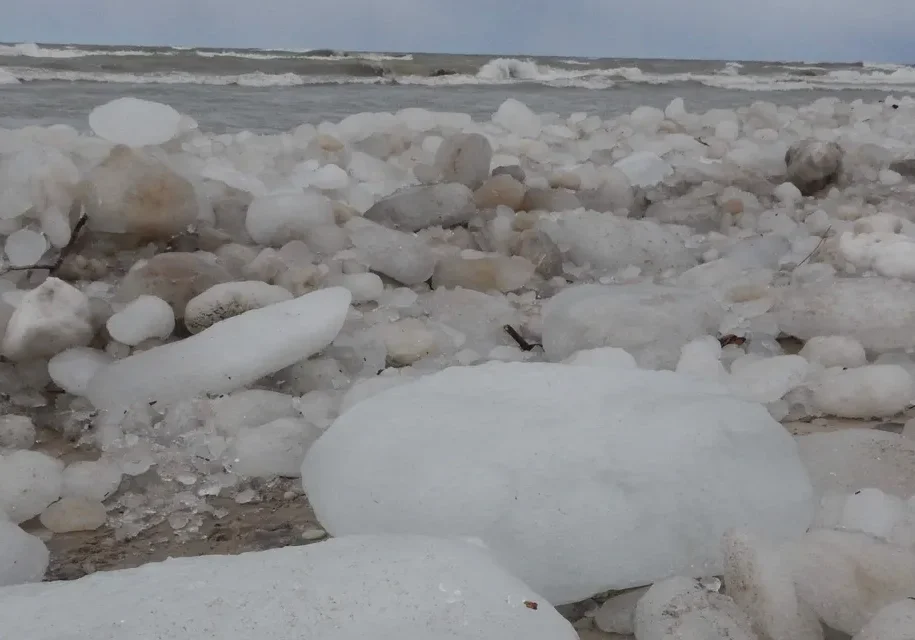 Frozen beach with scattered ice boulders