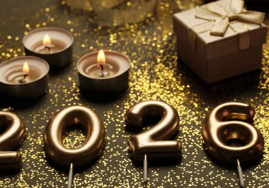 Gold 2026 candles with festive decorations